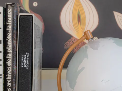 Foreign-language books beside a world globe